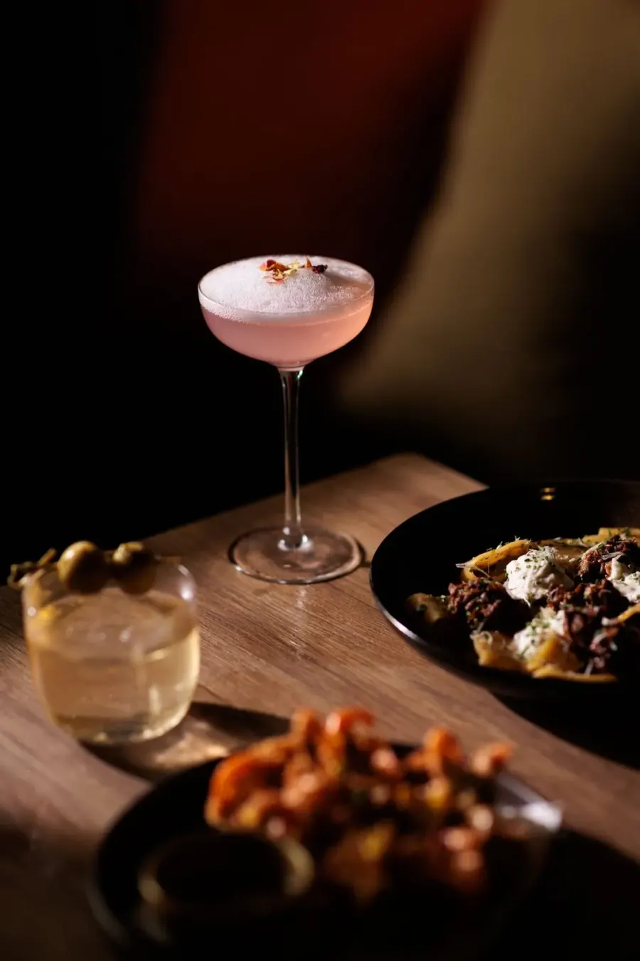 Pink cocktail with small plates
